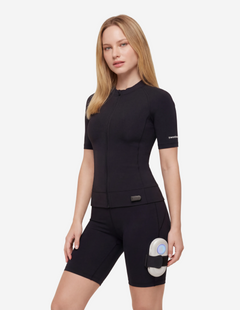 Women's black Sweetmyo AI full-body EMS suit with Nexus controller on thigh.